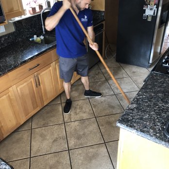 Man Cleaning The Floor Tiles